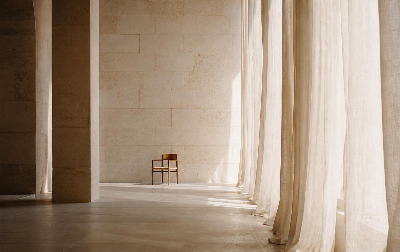 Soft morning light through linen curtains in a quiet ivory room